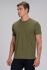 Homem de perfil vestindo camiseta masculina verde em algodão duplo egípcio Urbô, com tatuagem de âncora no braço.